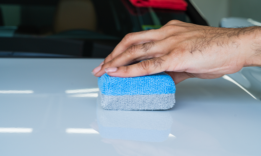 Applying ceramic coating with microfiber applicator on white car at Prestige Auto Appearance in Allentown PA