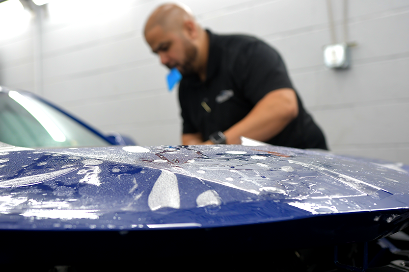 David installing matte paint protection film on a vehicle at Prestige Auto Appearance in Allentown PA