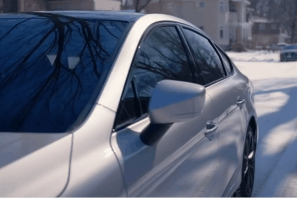 Close-up of ceramic tinted car windows reflecting winter light