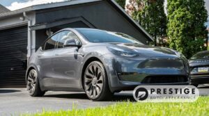 Silver Tesla Model Y parked outside Prestige Auto Appearance in Allentown, PA, after professional exterior detailing and paint protection.