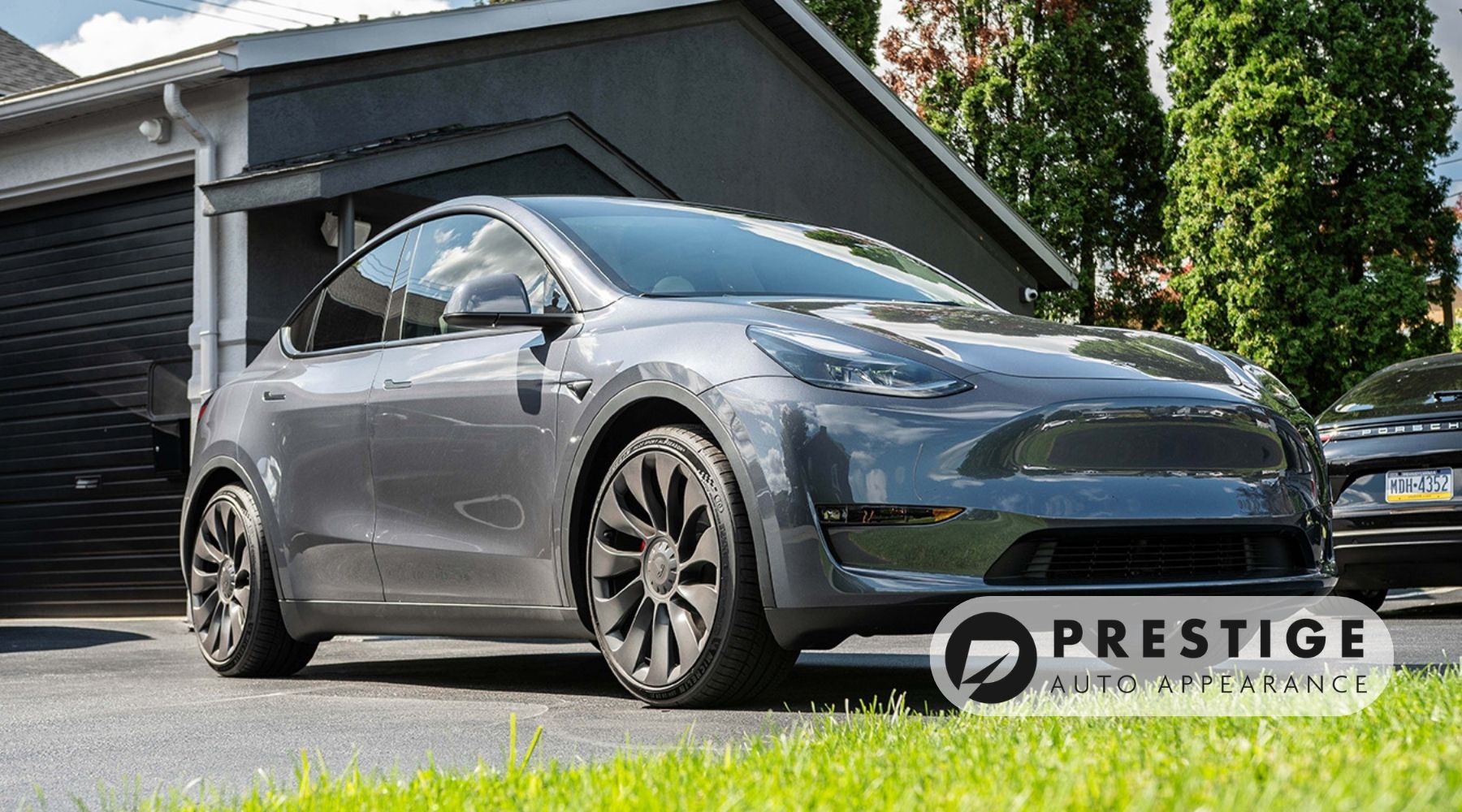 Silver Tesla Model Y parked outside Prestige Auto Appearance in Allentown, PA, after professional exterior detailing and paint protection.